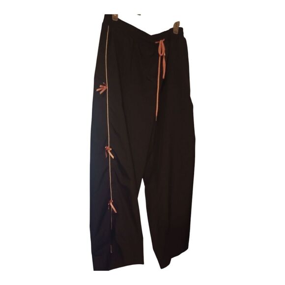 Elastic waist track style pants with pink bows accents on the sides - Picture 1 of 7